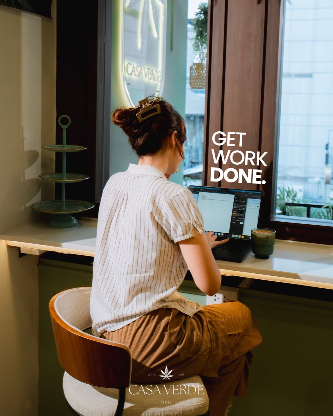 A guest working on a laptop at the window counter